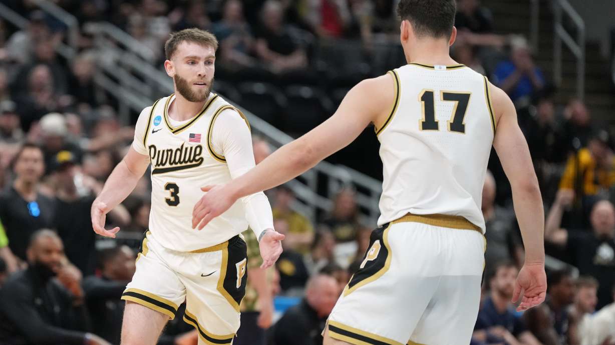 Purdue's Braden Smith (3) is congratulated by teammate Omer Mayer (17) after making a 3-point basket during the first half in the first round of the NCAA college basketball tournament against Queens University, Friday, March 20, 2026, in St. Louis.