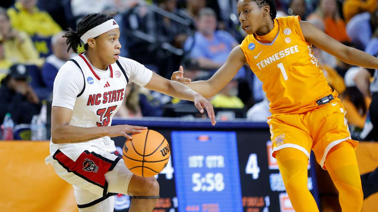 North Carolina State guard Zoe Brooks, left, drives against Tennessee guard Nya Robertson, right, during the first half in the first round of the NCAA college basketball tournament Friday, March 20, 2026, in Ann Arbor, Mich.