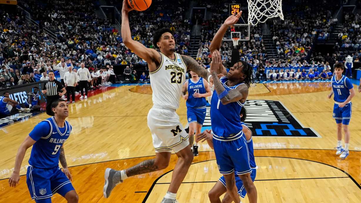 Michigan forward Yaxel Lendeborg (23) dunks over Saint Louis guard Quentin Jones (1) during the first half in the second round of the NCAA college basketball tournament, Saturday, March 21, 2026, in Buffalo, N.Y.