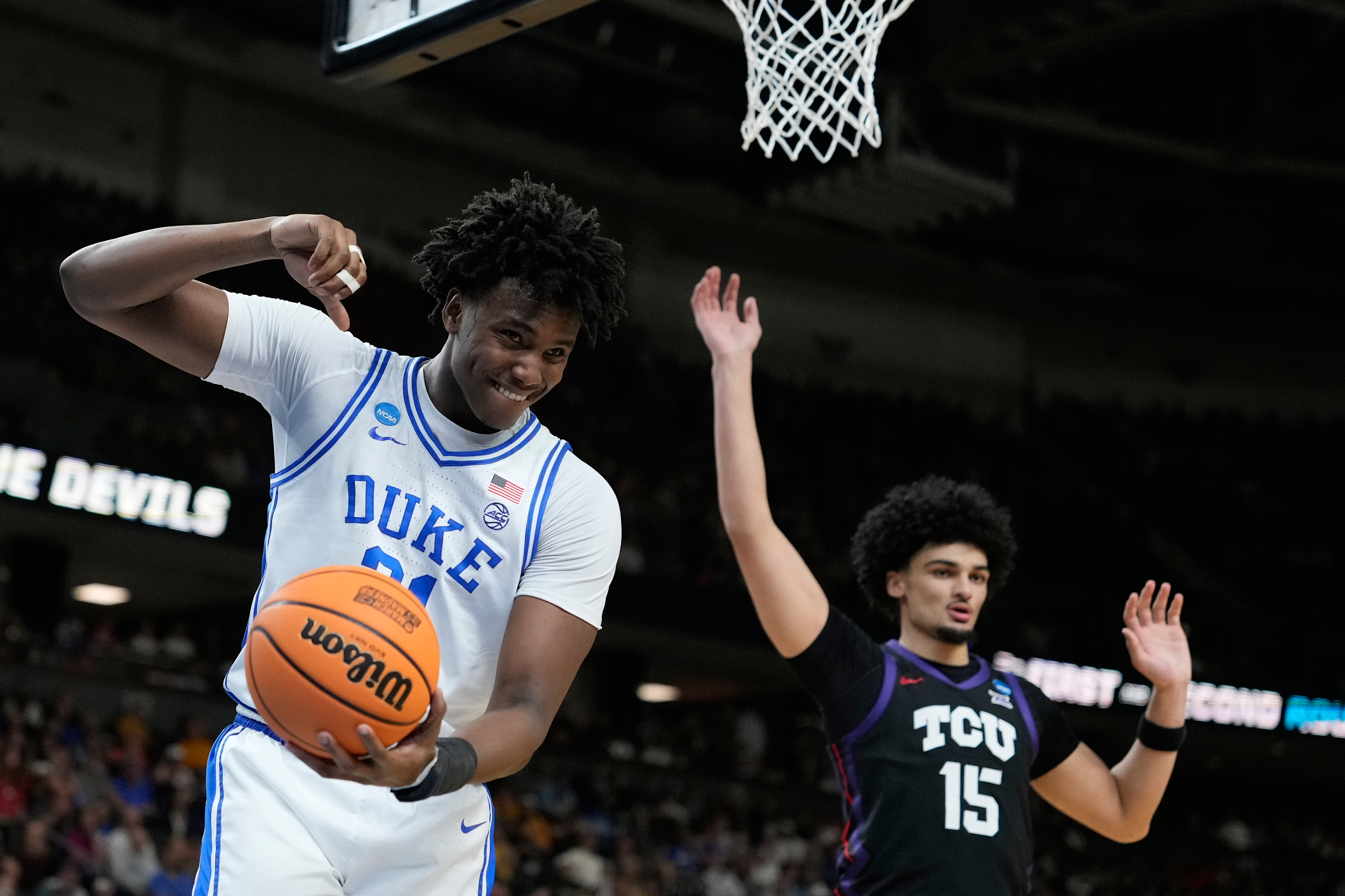 Duke center Patrick Ngongba (21) reacts after he releases the ball during the first half in the second round of the NCAA college basketball tournament against TCU, Saturday, March 21, 2026, in Greenville, S.C. 