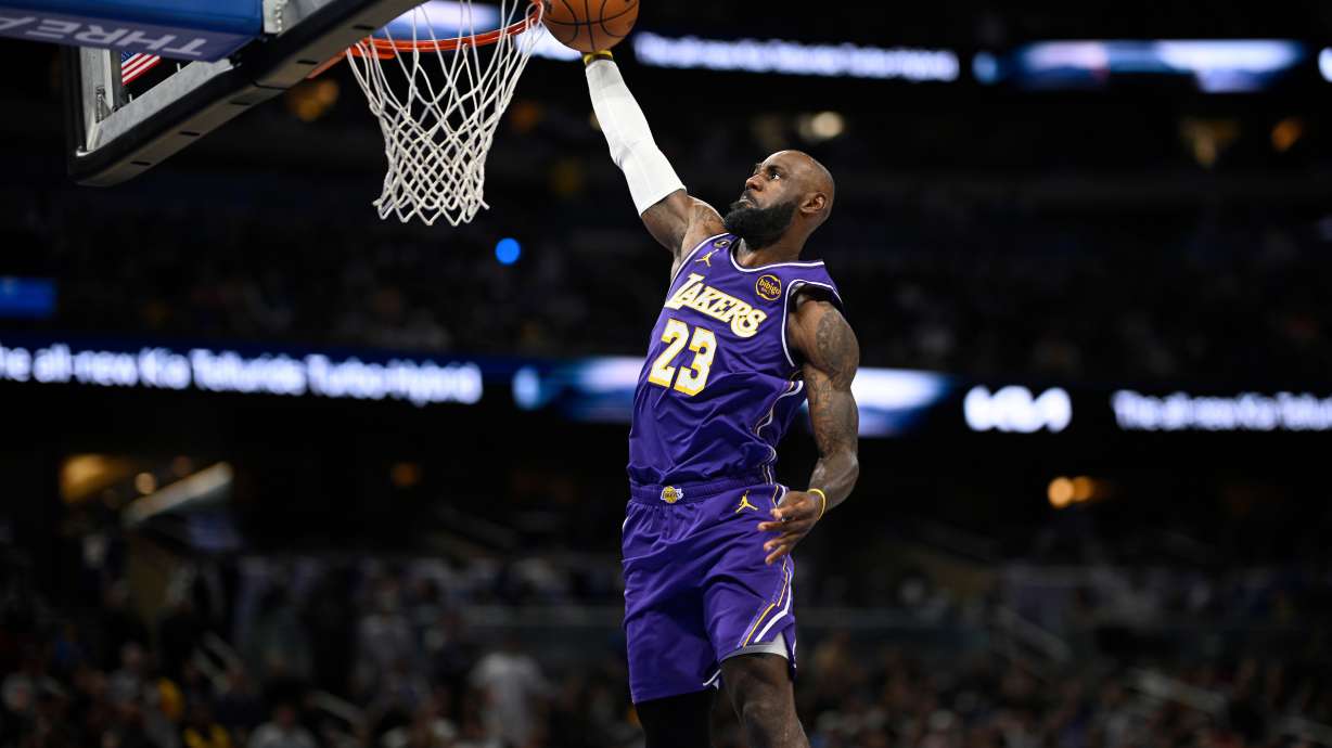 Los Angeles Lakers forward LeBron James (23) scores on a breakaway dunk during the first half of an NBA basketball game against the Orlando Magic, Saturday, March 21, 2026, in Orlando, Fla.