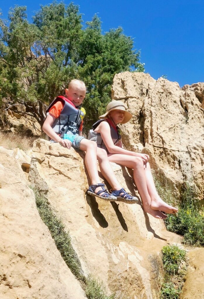 Rockwell Gundersen sits on a rock. Rockwell is in the hospital after he was hit by an SUV while riding an electric scooter in West Jordan.