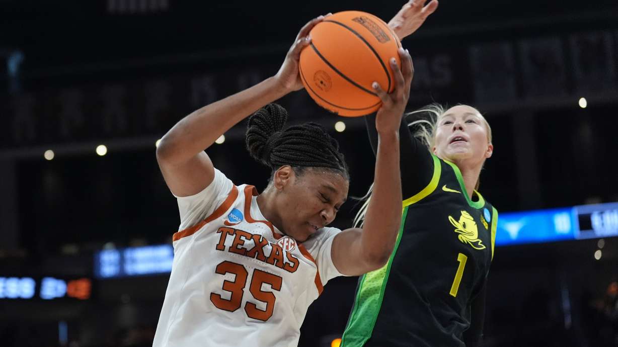 Texas forward Madison Booker (35) grabs a rebound in front of Oregon forward Mia Jacobs (1) during the first half in the second round of the NCAA college basketball tournament, Sunday, March 22, 2026, in Austin, Texas.