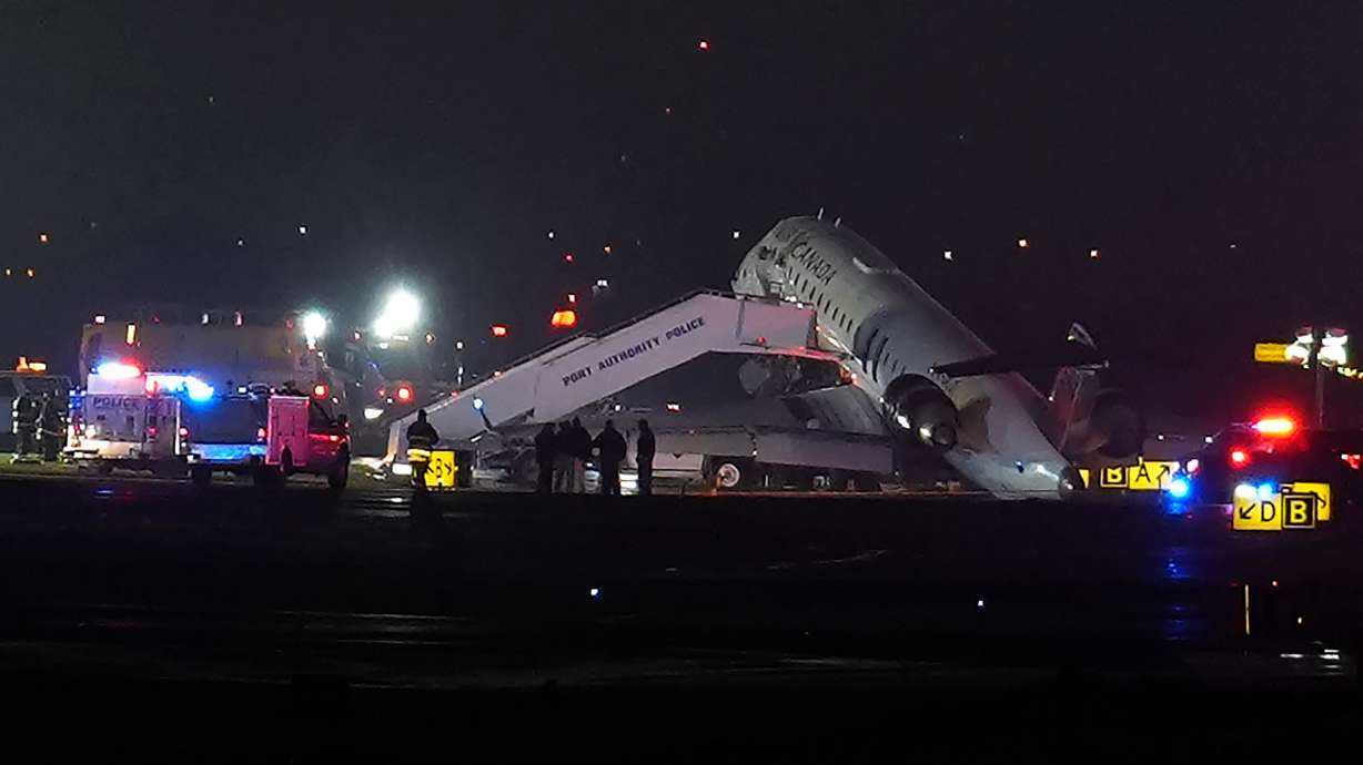 An Air Canada Jet sits on the runway at LaGuardia Airport, Monday, after colliding with a Port Authority vehicle in New York.