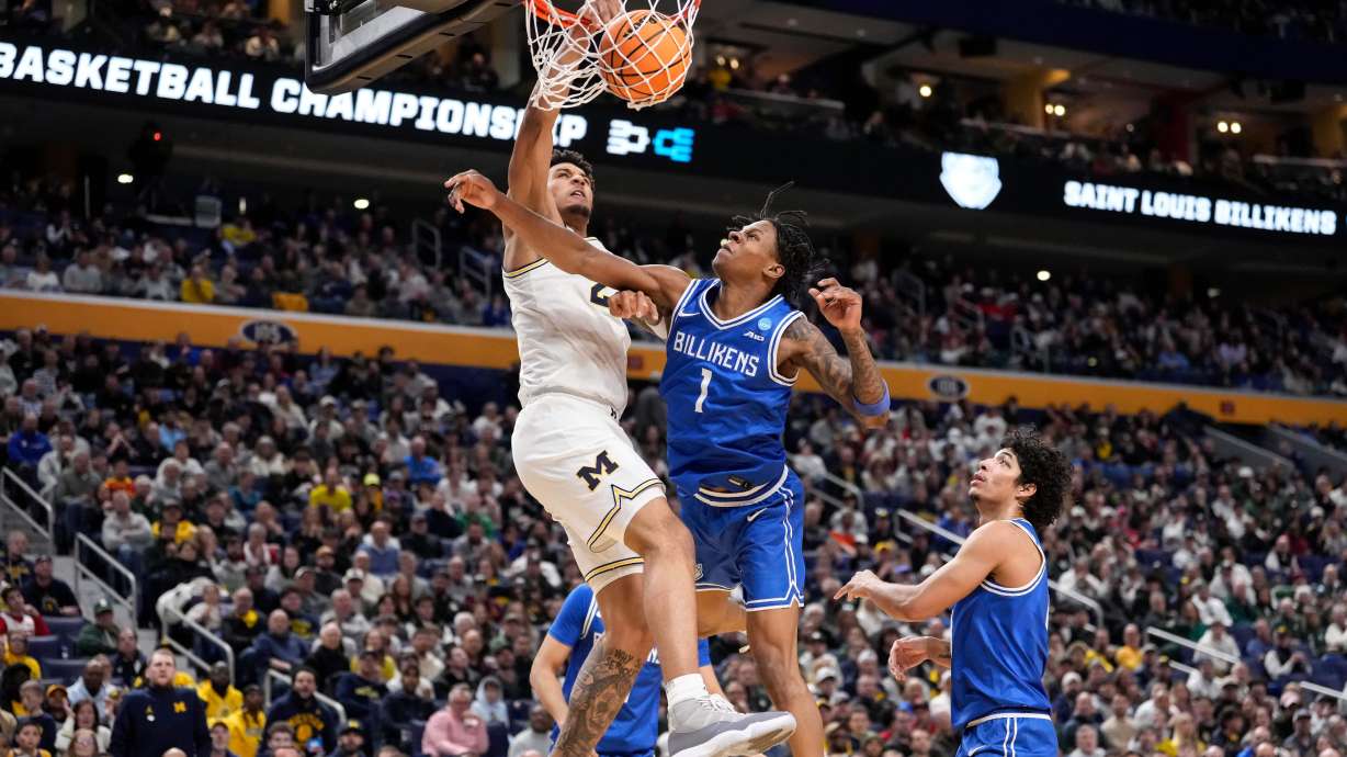 Michigan forward Yaxel Lendeborg (23) dunks over Saint Louis guard Quentin Jones (1) during the second half in the second round of the NCAA college basketball tournament, Saturday, March 21, 2026, in Buffalo, N.Y.
