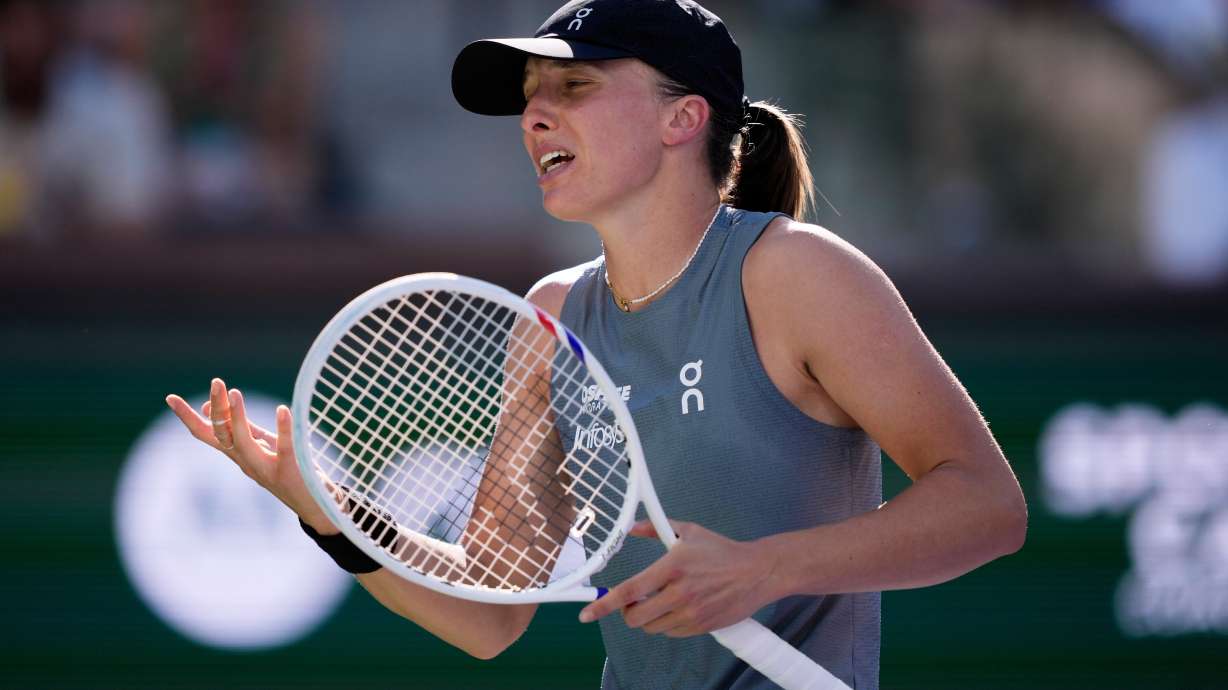 Iga Swiatek, of Poland, reacts after losing a point against Elina Svitolina, of Ukraine, during a quarterfinal match at the BNP Paribas Open tennis tournament, Thursday, March 12, 2026, in Indian Wells, Calif.