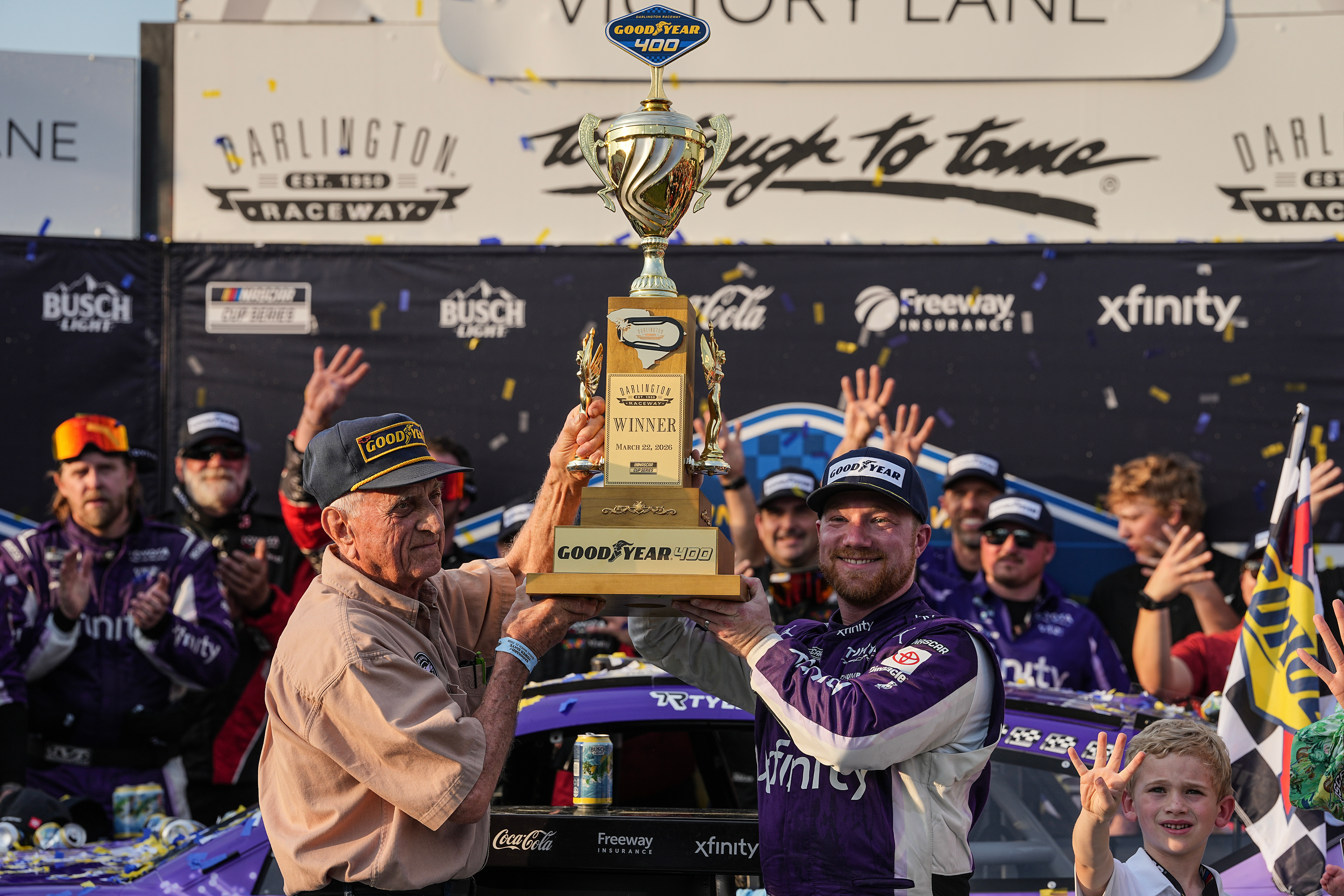 Tyler Reddick, center right, celebrates with his team in Victory Lane after winning a NASCAR Cup Series auto race, Sunday, March 22, 2026, in Darlington, S.C.