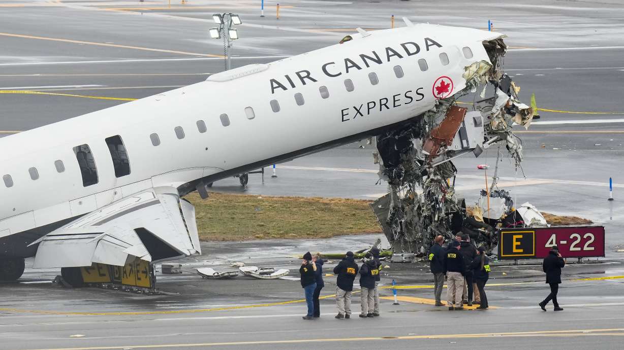 Officials with the National Transportation Safety Board on Monday investigate the site where an Air Canada jet came to rest after colliding with a Port Authority firetruck at LaGuardia Airport Sunday night in New York.