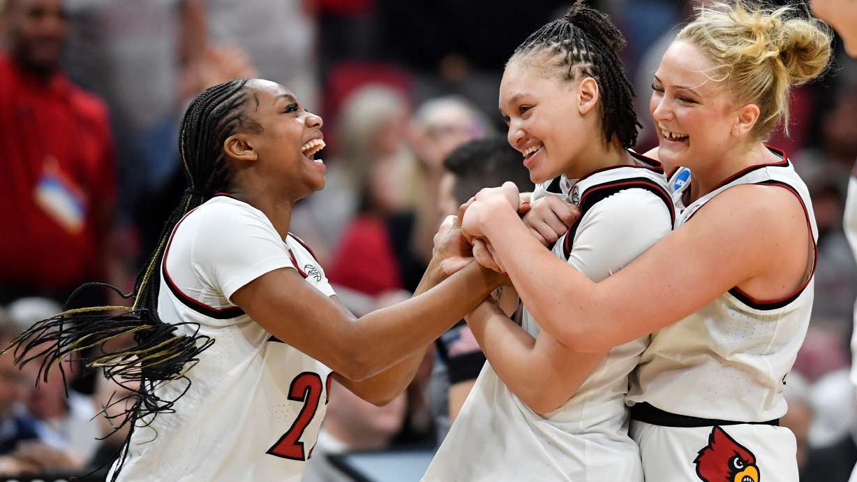 Louisville forward Laura Ziegler, right, and guard Tajianna Roberts (22) celebrate with guard Imari Berry, center, after Berry made two free throws to put Louisville ahead during the second half in the second round of the NCAA college basketball tournament against Alabama, Monday, March 23, 2026, in Louisville, Ky.