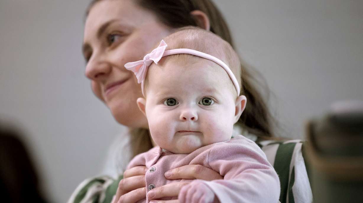 Ellie Farmer is held by her mother, Jadree Farmer, at a press conference on life-saving organ transplants for children at Primary Children’s Hospital on Monday. Ellie Farmer received a liver transplant when she was 7 months old.
