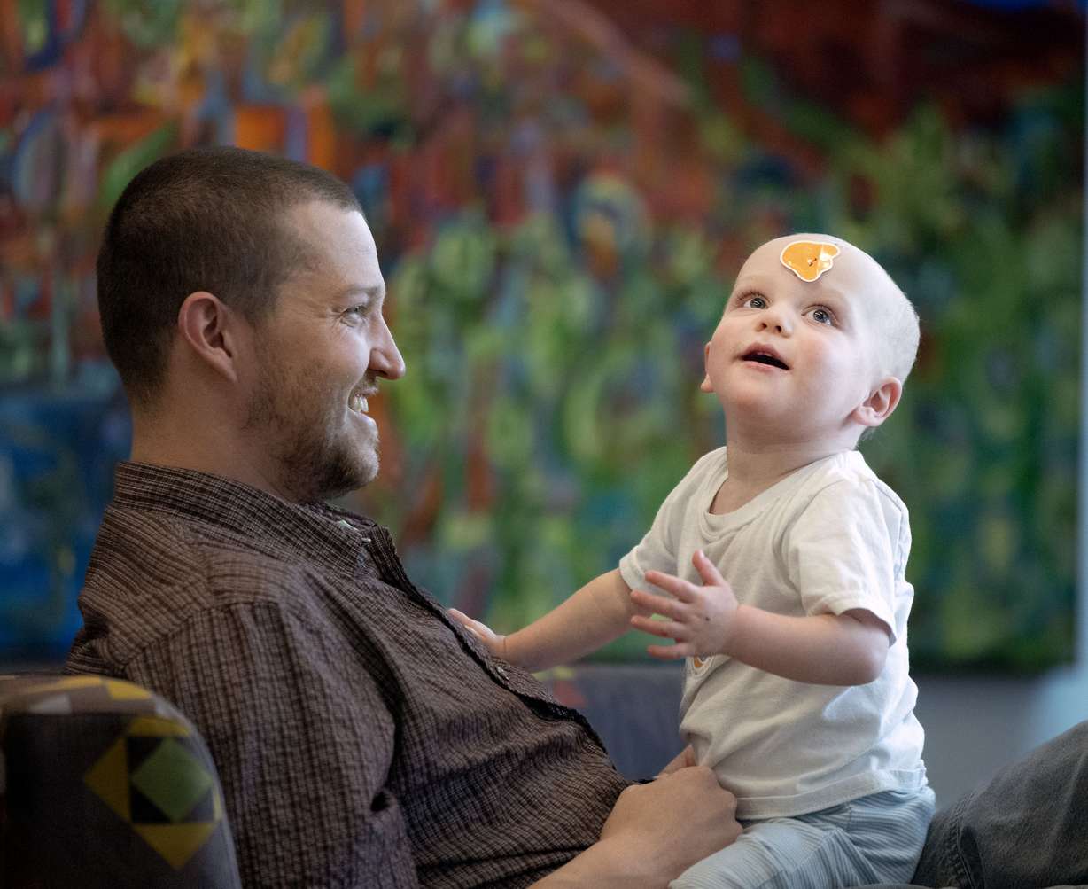 Alec Whitney plays with his son, Alonzo, before a press conference concerning life-saving organ transplants for children at Primary Children’s Hospital on Monday. Alonzo received a heart transplant when he was 6½ weeks old.