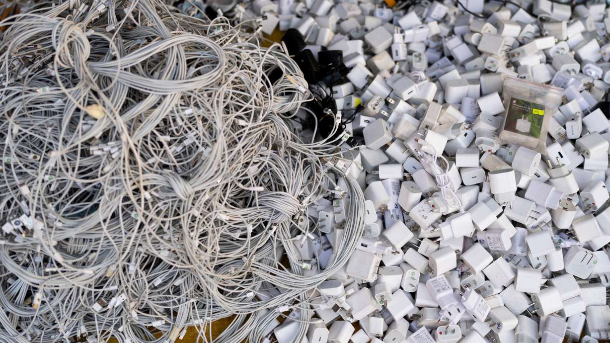 Used charging cables and power adapters are piled up at a shop in Nhat Tao market, a recycling market in Ho Chi Minh City, Vietnam, Jan. 28, 2024. Experts say that if we knew how to recycle things like these, costs of electronics would drop.