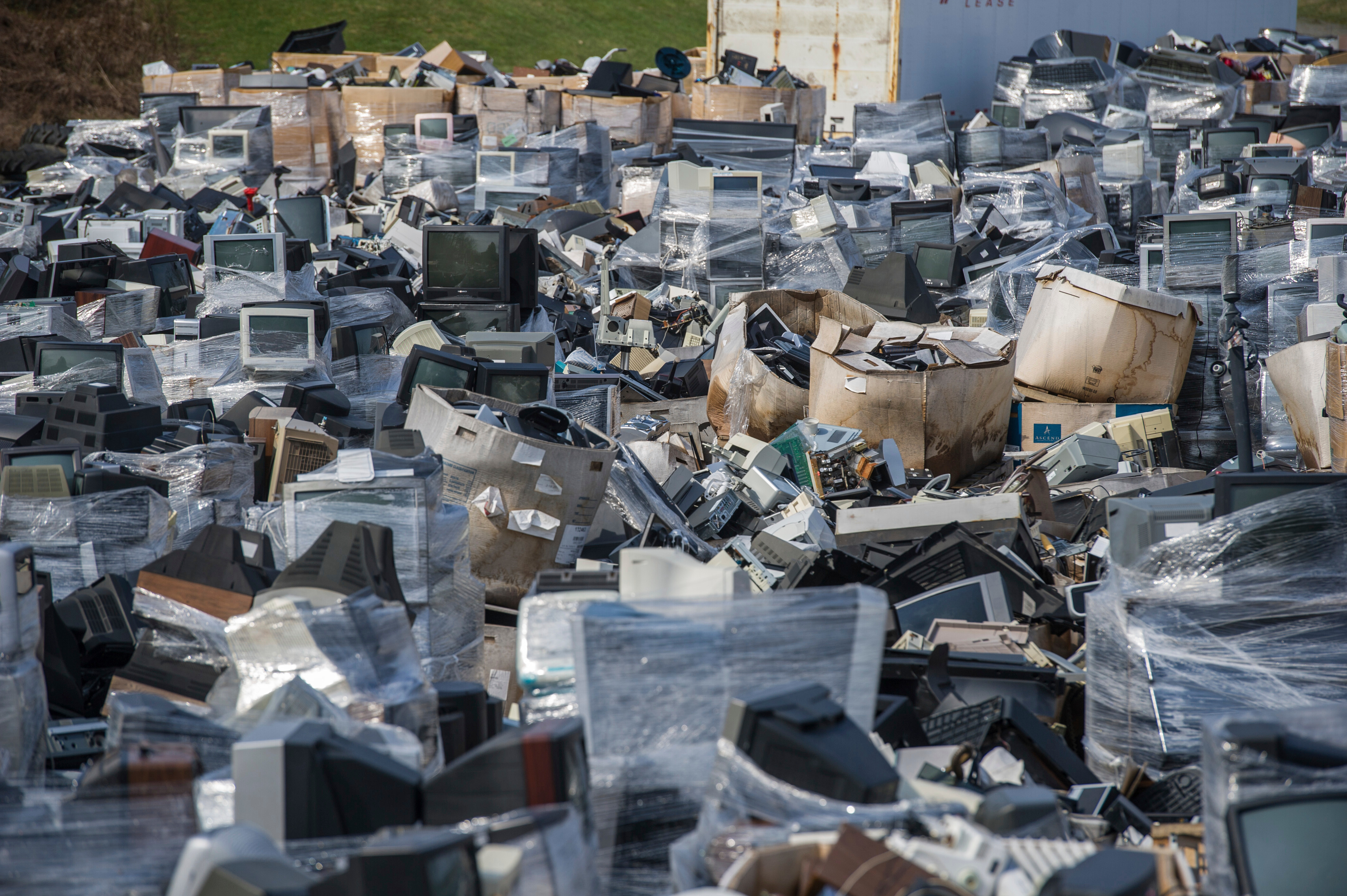 A sea of electronic waste, consisting mostly of televisions, microwaves and computers, cover the landscape at Westmoreland Cleanways and Recycling, in Unity, Pa., March 24, 2017. Efforts to recycle e-waste, experts say, can keep harmful materials out of landfills.