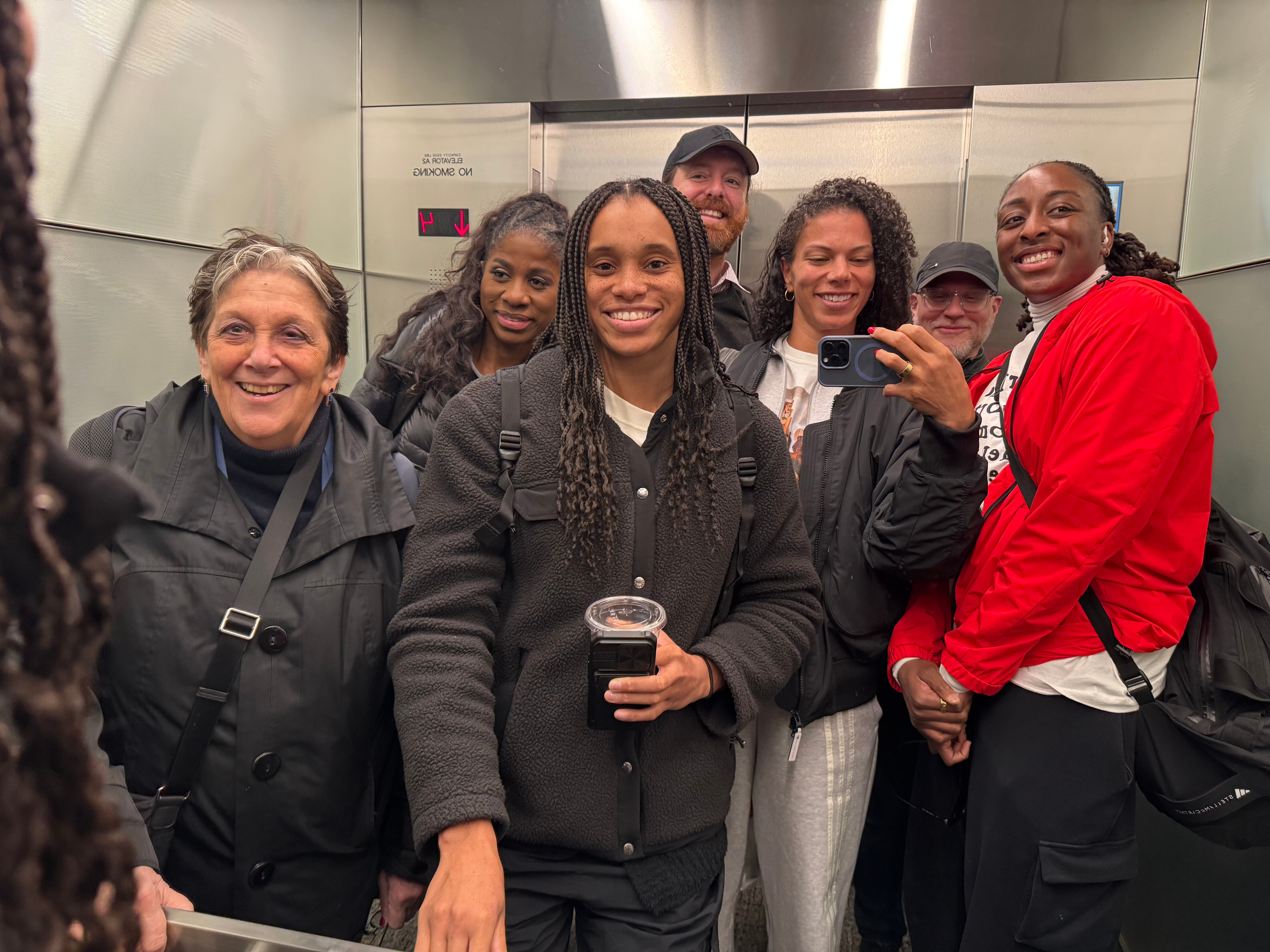 WNBA players and union members pose for a photo in an elevator after a negotiating session at the NBA headquarters on March 13, 2026, in New York. 