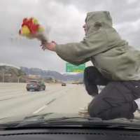 Utahn arrested after allegedly posting viral video of him riding hood of car on I-215