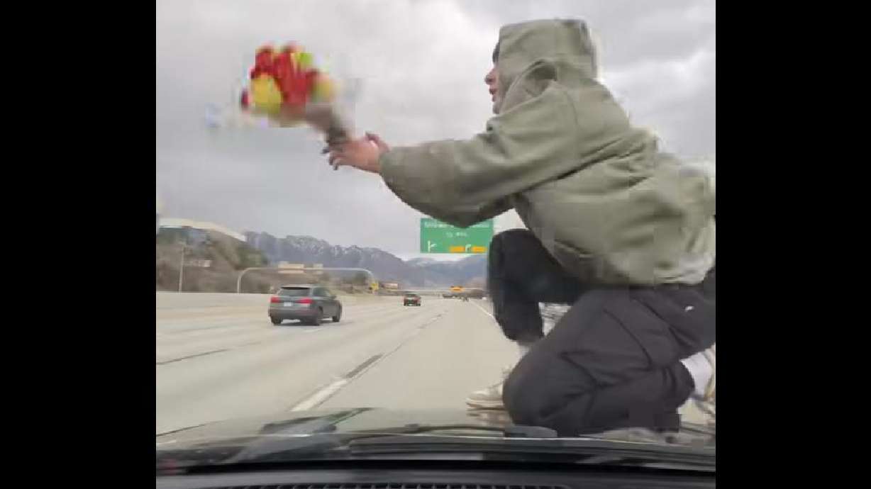 A Utah "digital creator" who created a viral video by allegedly filming himself riding on the hood of a moving vehicle on I-215 has been arrested by the Utah Highway Patrol.