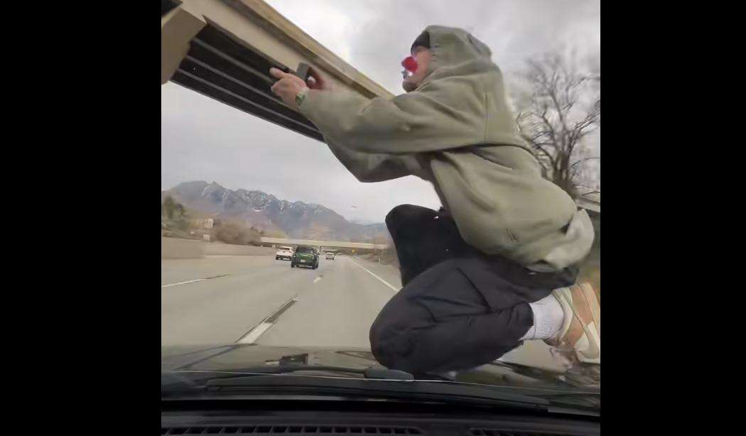 A West Valley man who allegedly posted a viral video of himself riding on the hood of a car on I-215 was tracked down and arrested by the Utah Highway Patrol.