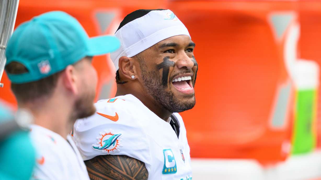FILE - Miami Dolphins quarterback Tua Tagovailoa smiles on the bench during an NFL football game against the New Orleans Saints, Nov. 30, 2025, in Miami Gardens, Fla.