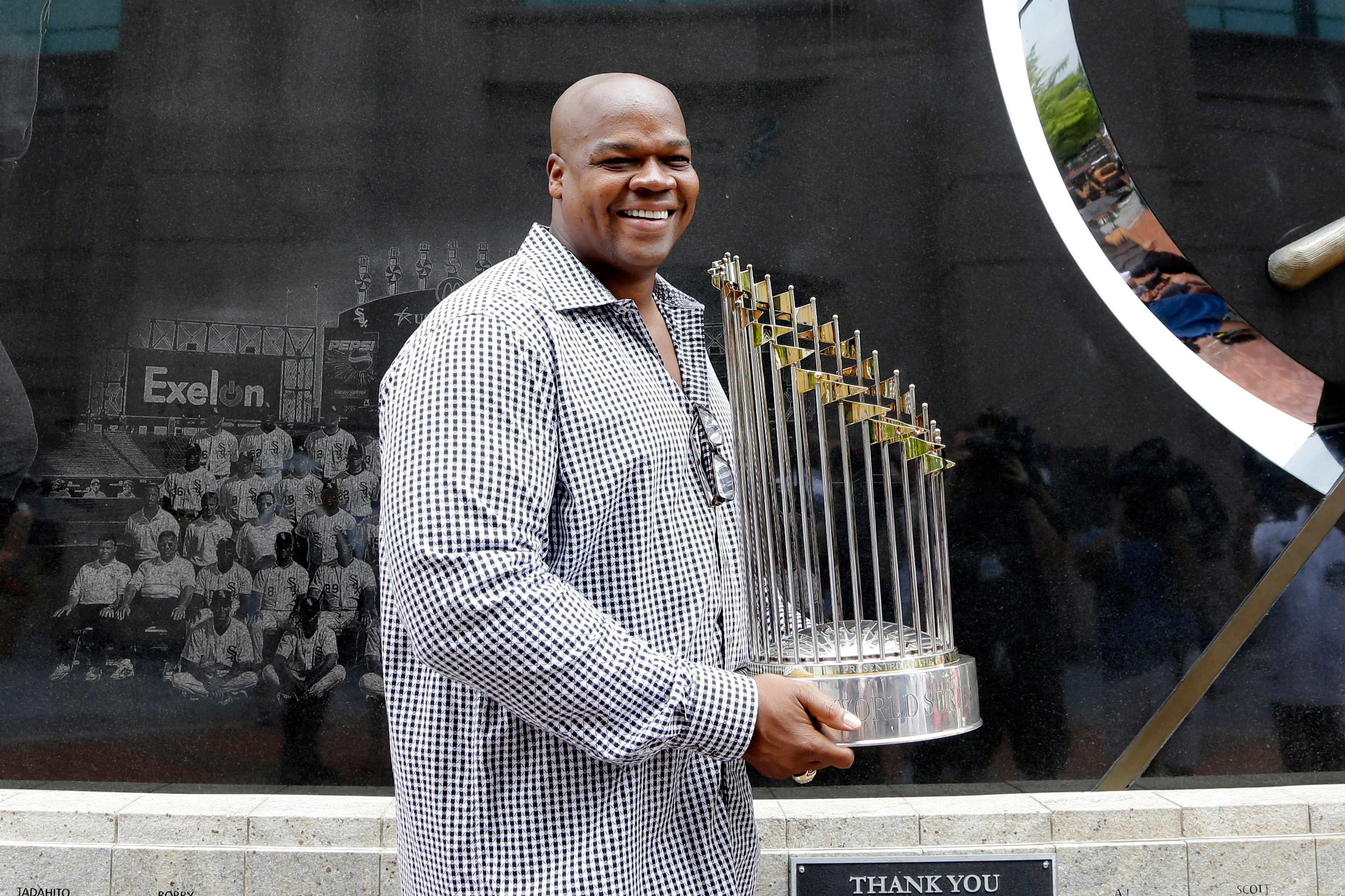 FILE - Former Chicago White Sox player and Hall of Famer Frank Thomas holds the 2005 World Series Champion trophy before a baseball game between the Kansas City Royals and the Chicago White Sox in Chicago, on July 18, 2015. 