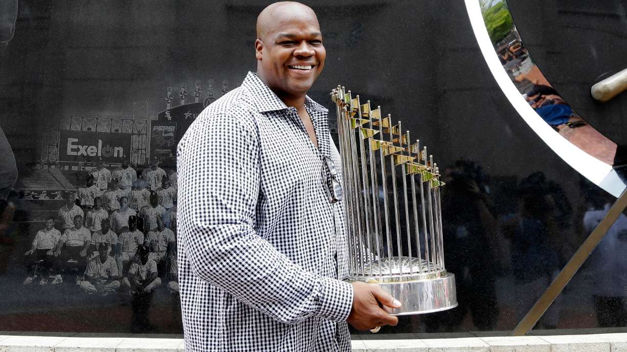 FILE - Former Chicago White Sox player and Hall of Famer Frank Thomas holds the 2005 World Series Champion trophy before a baseball game between the Kansas City Royals and the Chicago White Sox in Chicago, on July 18, 2015.