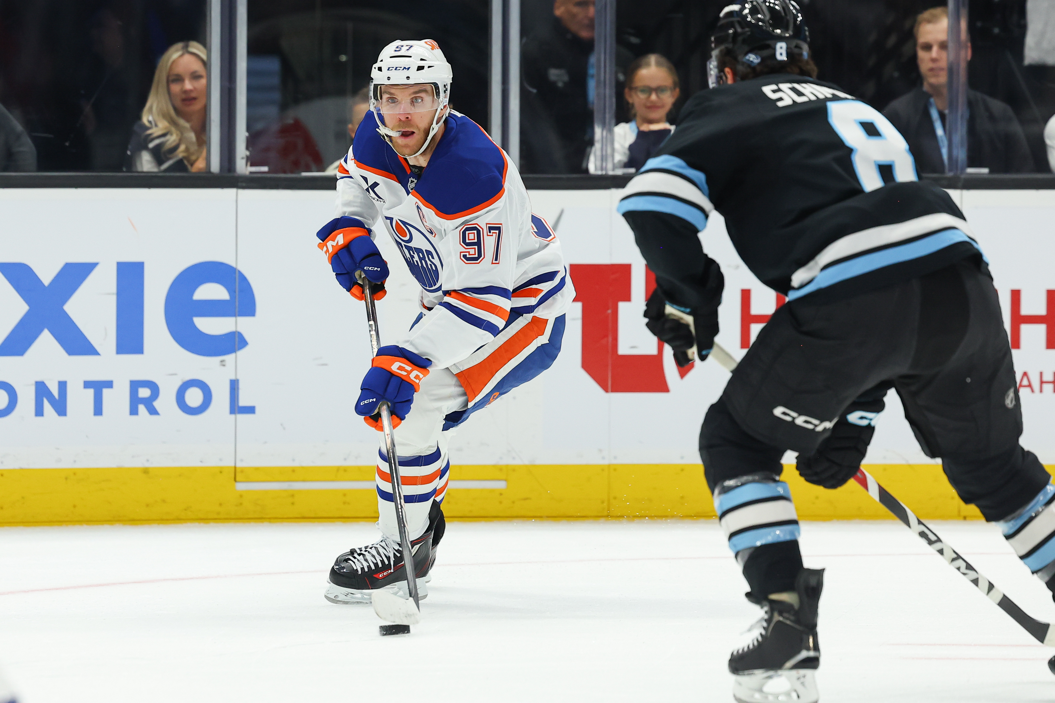 Edmonton Oilers center Connor McDavid (97) controls the puck against Utah Mammoth center Nick Schmaltz (8) during the first period of an NHL hockey game, Tuesday, March 24, 2026, in Salt Lake City.