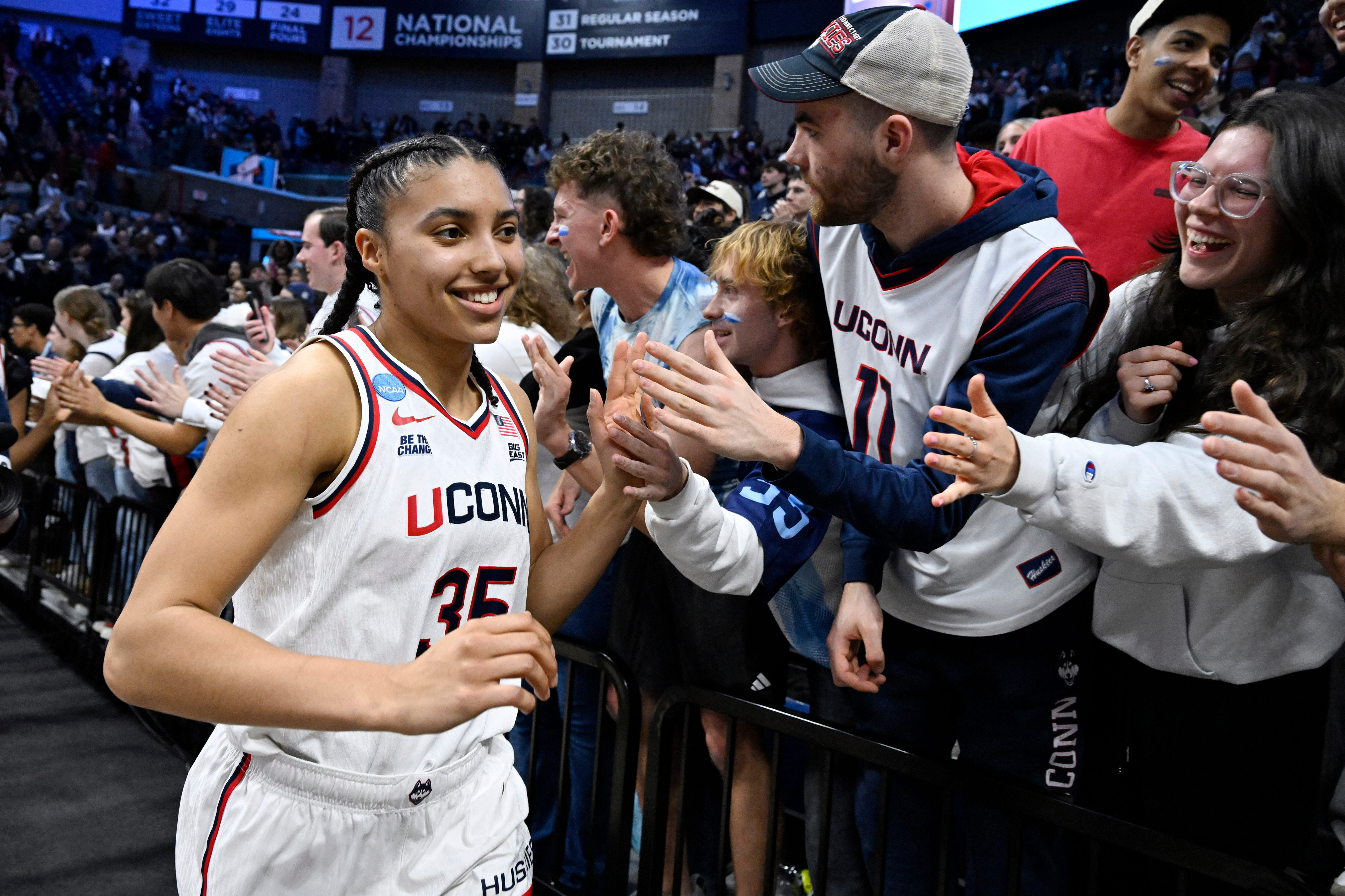 UConn guard Azzi Fudd (35) slaps hands with students at the end of a game against Syracuse in the second round of the NCAA college basketball tournament, Monday, March 23, 2026, in Storrs, Conn. 