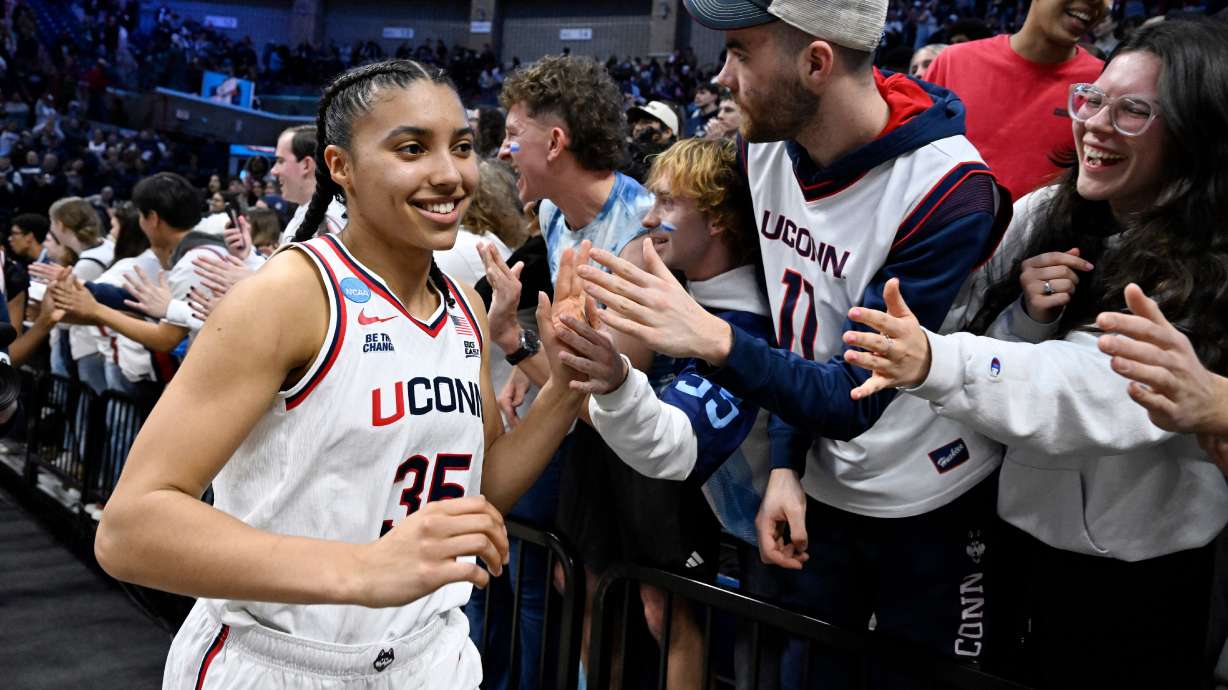 UConn guard Azzi Fudd (35) slaps hands with students at the end of a game against Syracuse in the second round of the NCAA college basketball tournament, Monday, March 23, 2026, in Storrs, Conn.