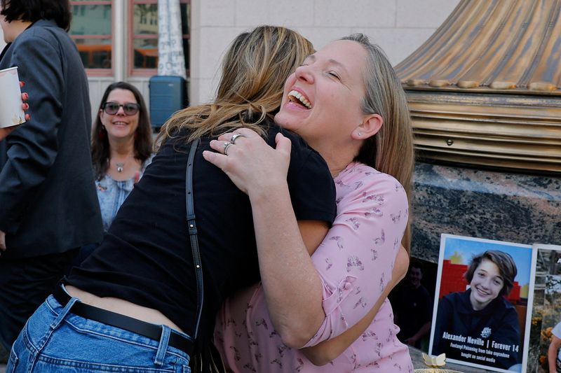 Amy Neville, mother of Alexander, is embraced outside the court as she awaits the jury's verdict in a key test case accusing Meta and Google's YouTube of harming children's mental health through addictive social media platforms, in Los Angeles, Calif., Wednesday. The jury found both companies liable for over $6 million in damages.