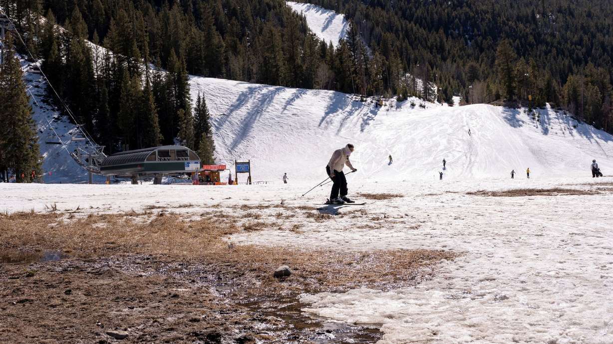 A skier navigates dirt patches at Keystone Ski Resort in Colorado on March 21. States across the West dealt with below-average snowpack this season, which is leading to similar challenges facing Utah.