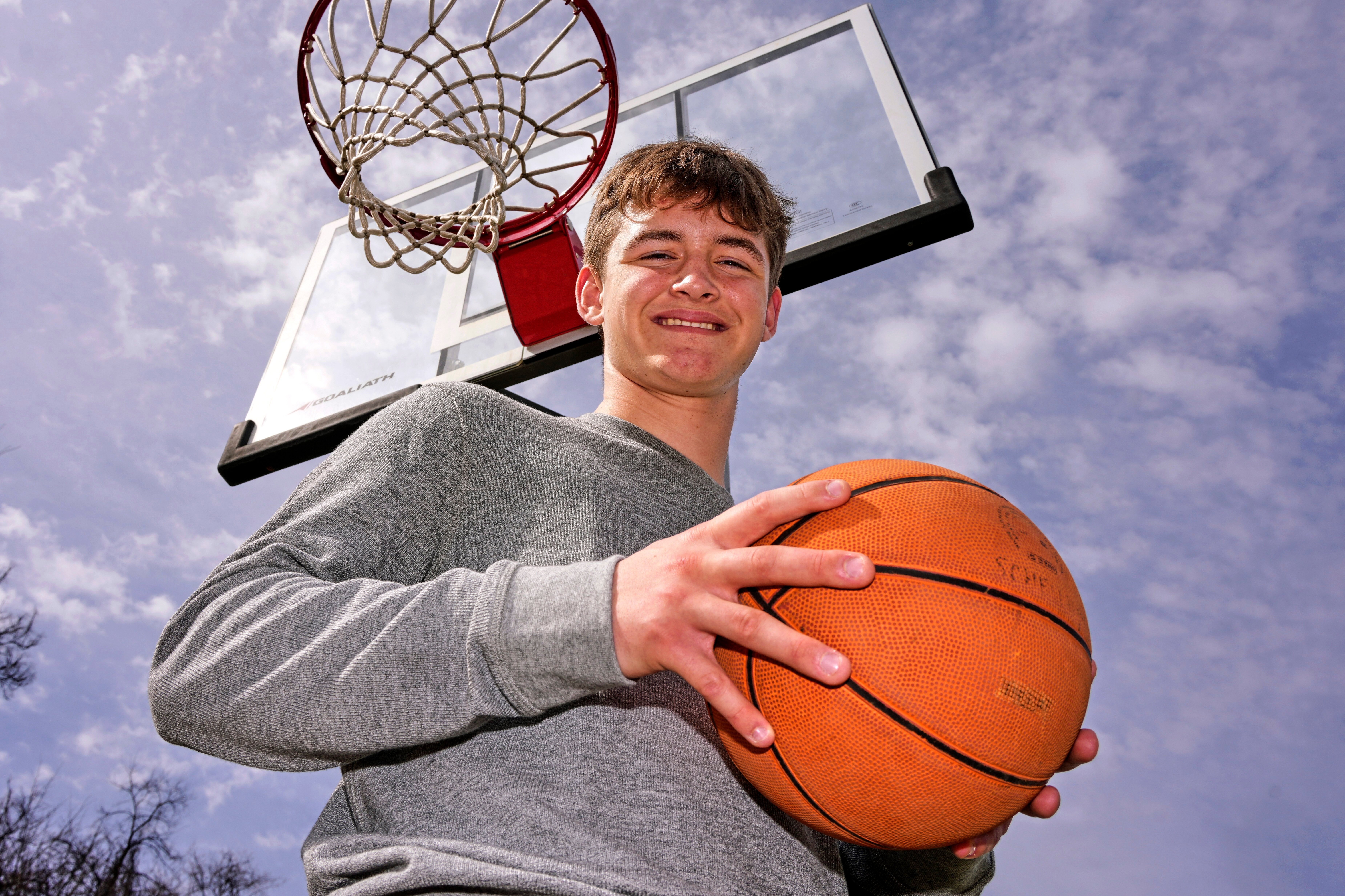 Otto Schellhamer, an eighth-grader who has the only perfect bracket after the opening weekend of the men’s and women’s NCAA college basketball tournaments, poses in his backyard in Plum Borough, Pa., Wednesday, March 25, 2026. 