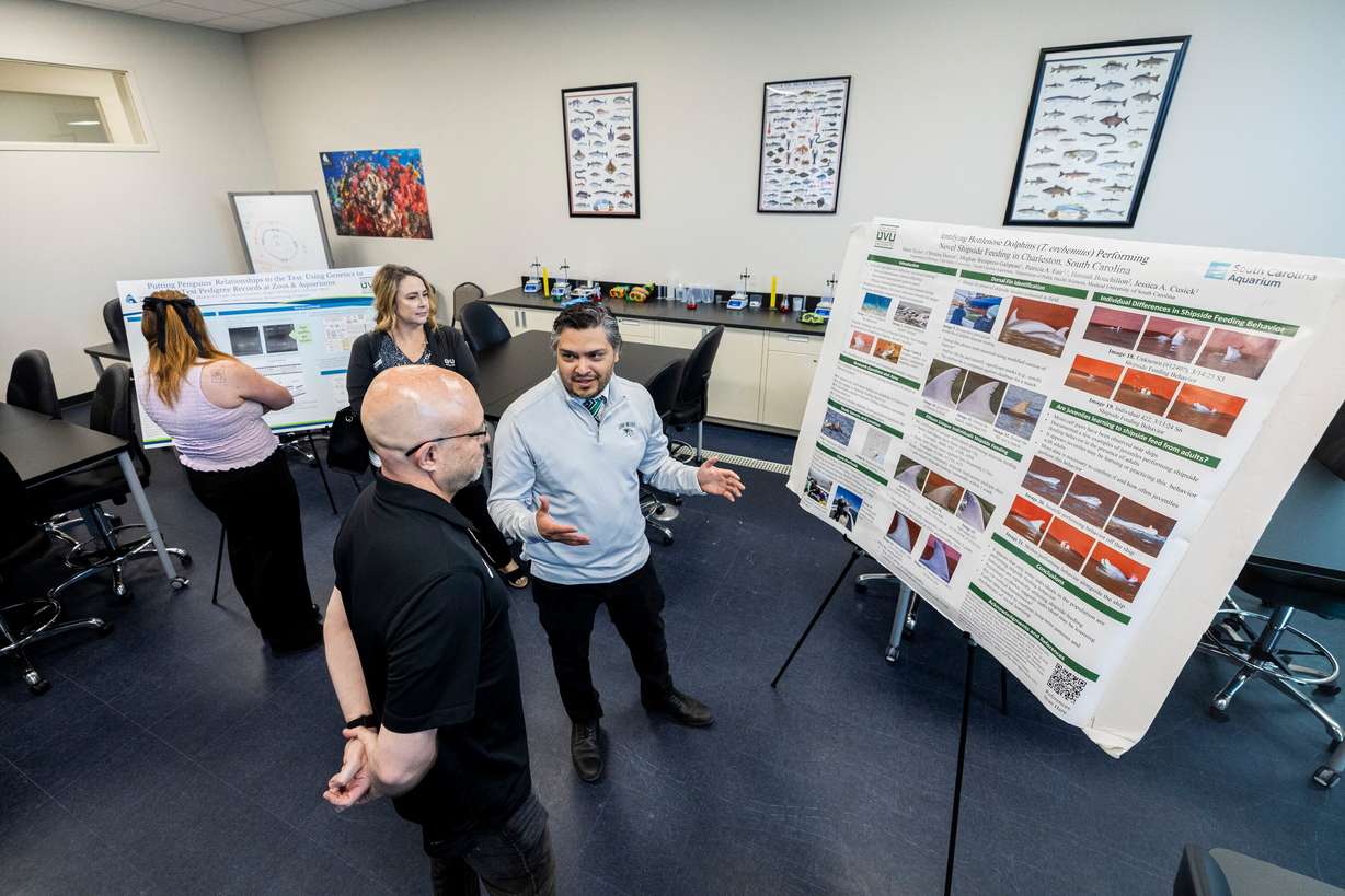 Chris Gonzalez, a marketing manager with Utah Valley University’s College of Science, explains research to attendees in UVU’s new lab area during an event announcing a partnership between UVU and the Loveland Living Planet Aquarium in Draper on Wednesday.