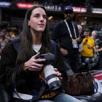 Caitlin Clark works as a photographer for the Indiana Pacers as they host LeBron and the Lakers