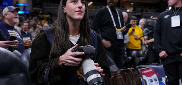 Caitlin Clark works as a photographer for the Indiana Pacers as they host LeBron and the Lakers