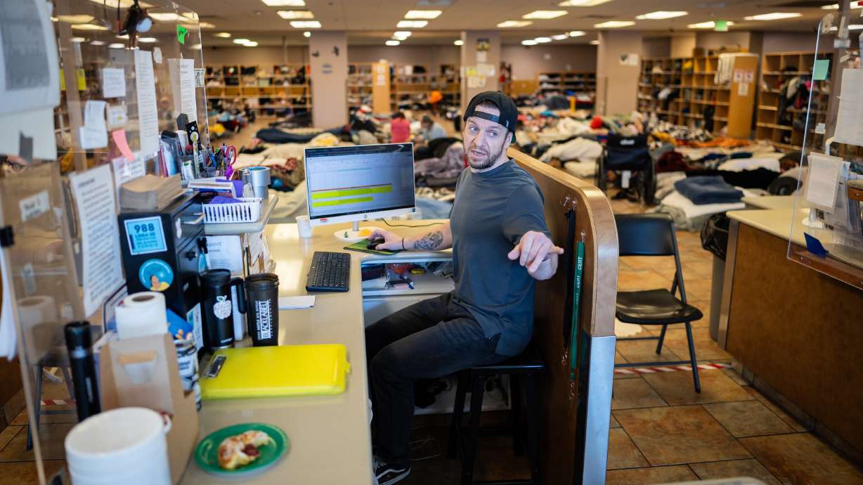 Lanny Outcalt, site manager, tells a person to leave after they yelled inside Switchpoint's Salt Lake Overflow Shelter in West Valley City on Wednesday.