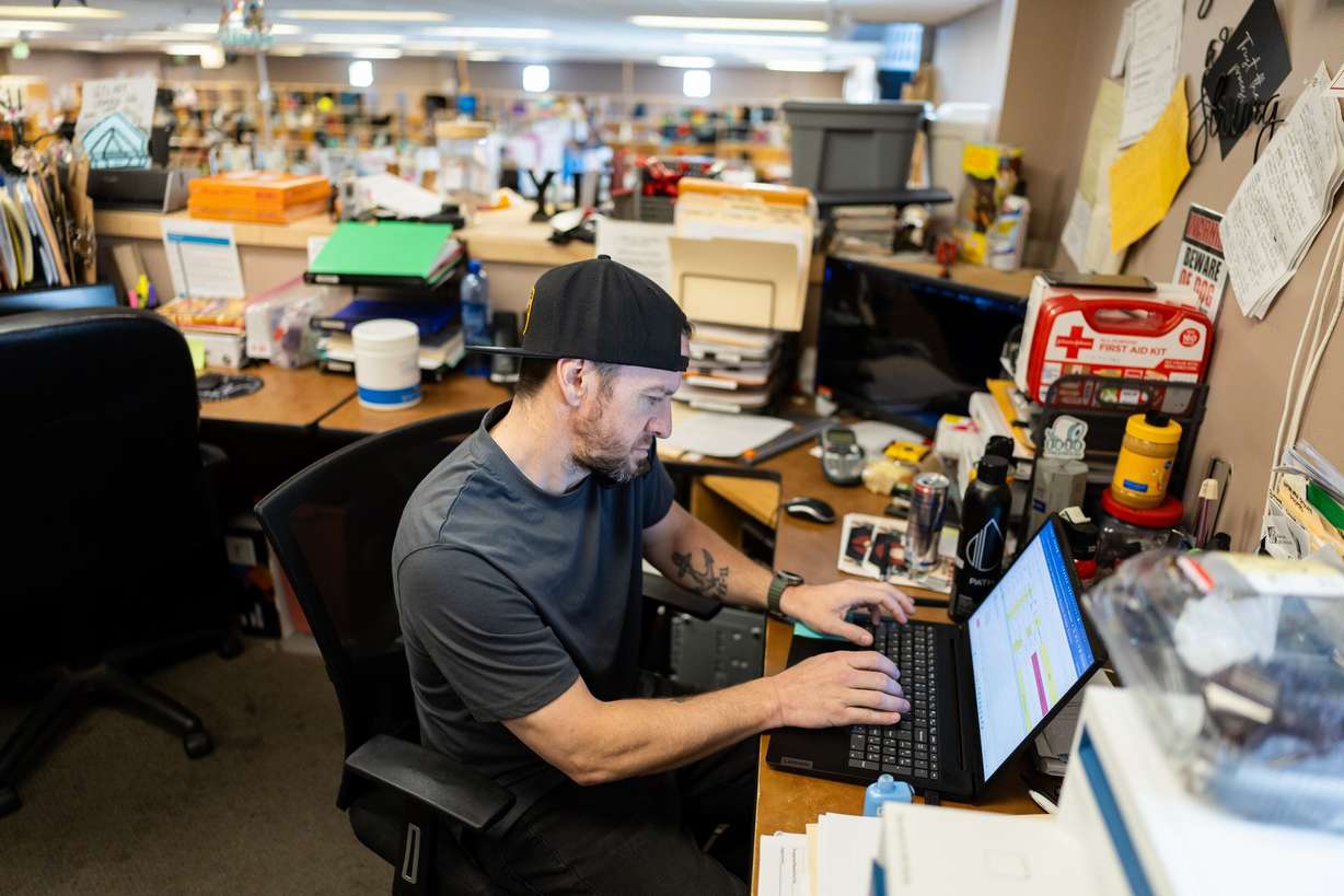 Lanny Outcalt, site manager, takes a call while working on his laptop at Switchpoint's Salt Lake Overflow Shelter in West Valley City on Wednesday.