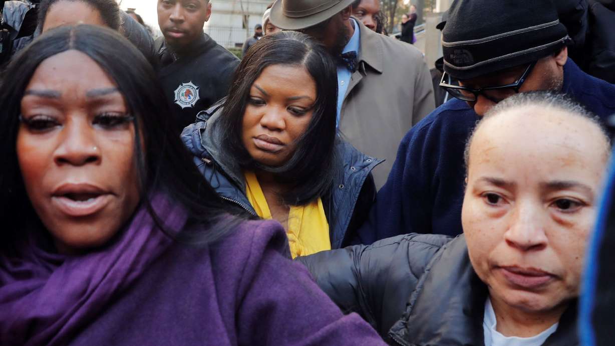 Tova Noel, center, is surrounded by fellow guards as she departs a court hearing regarding her actions the evening of Jeffrey Epstein's death in prison, outside a federal court in New York, on Nov. 25, 2019.