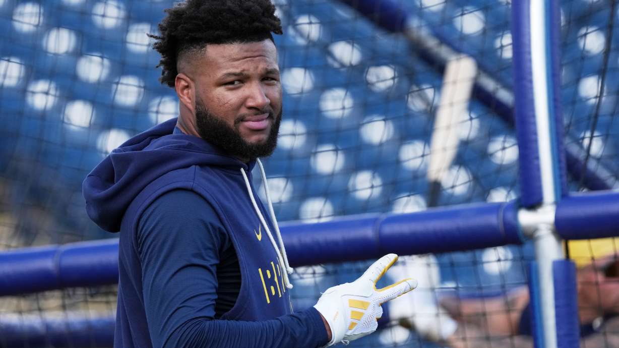 FILE - Milwaukee Brewers' Jackson Chourio gestures during a spring training baseball workout, Feb. 18, 2026, in Phoenix.