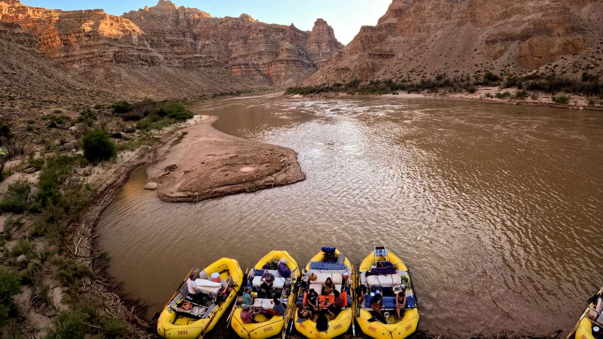 Boaters lounge on rafts near a mudbank at Lower Ten Cent campsite in Cataract Canyon on the Colorado River on Sept. 19, 2024. Utah added four new members to its Colorado River Authority of Utah board on Tuesday.