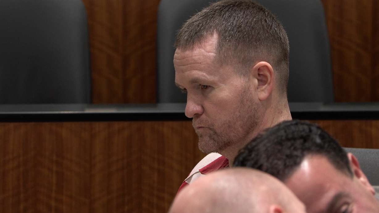 Michael Jayne sits with his attorneys during the second part of his preliminary hearing on March 26. He was ordered to stand trial for aggravated murder in a written ruling on Monday.