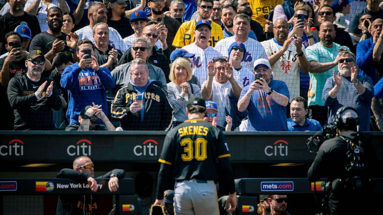 The crowd cheers and jeers as Pittsburgh Pirates pitcher Paul Skenes (30) exits the field after he was relieved in the first inning of an opening-day baseball game against the New York Mets, Thursday, March 26, 2026, in New York.