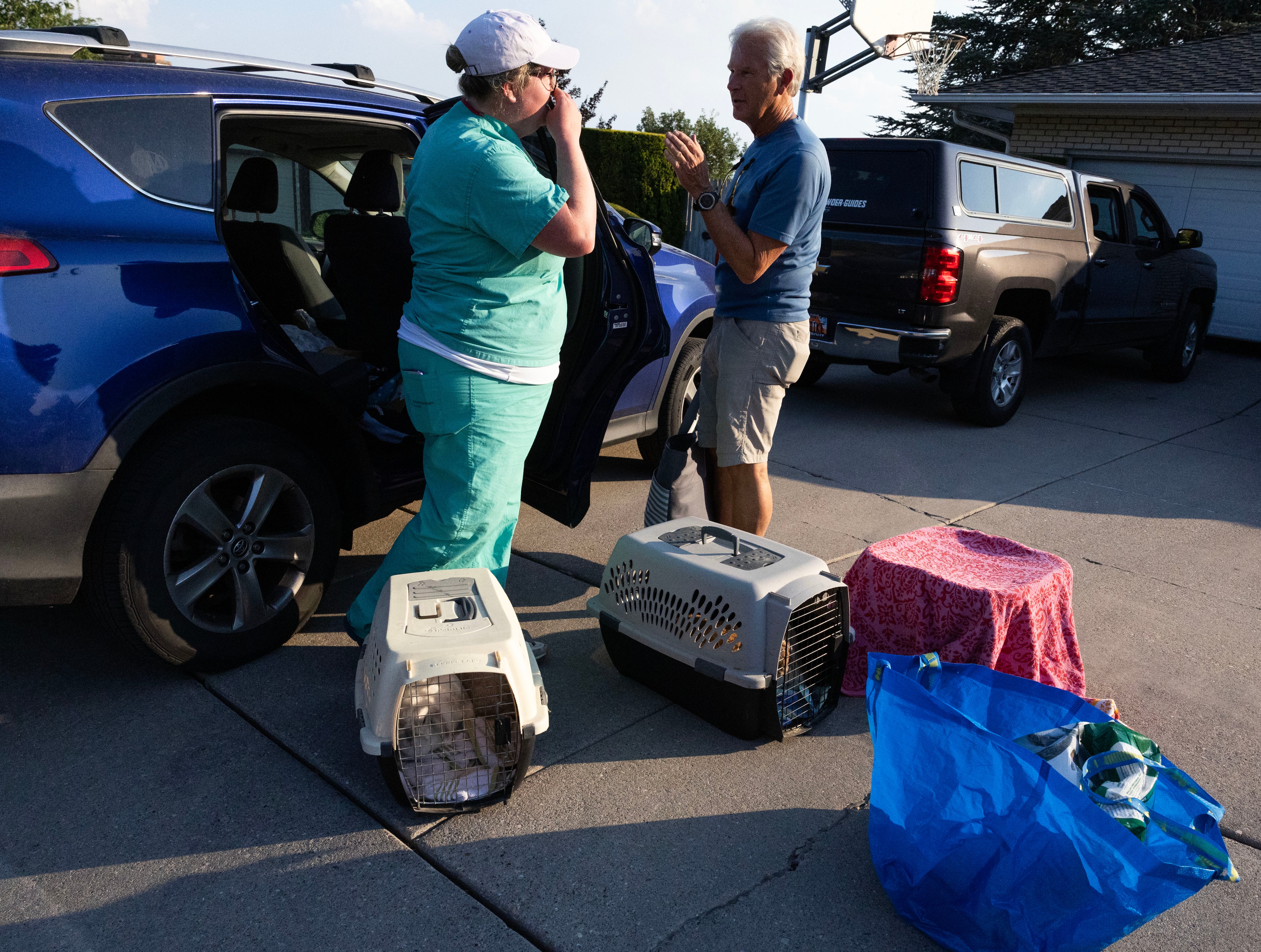 Heather White, who was house sitting for friends on vacation when they received an evacuation order, talks about what to do next with Curt Peterson after they evacuated with their friends three dogs, six bunnies and a bearded dragon because of the wildfire burning around Ensign Peak, which was encroaching on residential areas in Salt Lake City on July 20, 2024. Utah is preparing for what could be an active fire season.