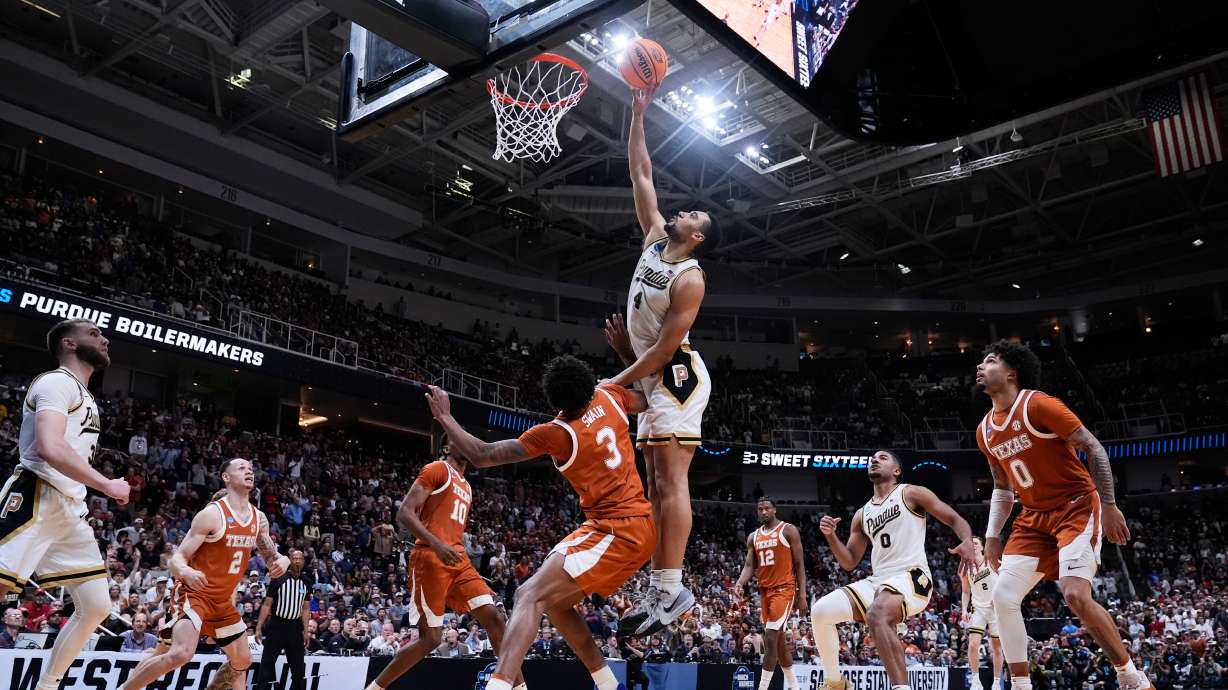 Purdue forward Trey Kaufman-Renn (4) tips the ball over Texas forward Dailyn Swain (3) for the game-winning basket over Texas forward Dailyn Swain (3) during the second half in the Sweet 16 of the NCAA college basketball tournament, Thursday, March 26, 2026, in San Jose, Calif.