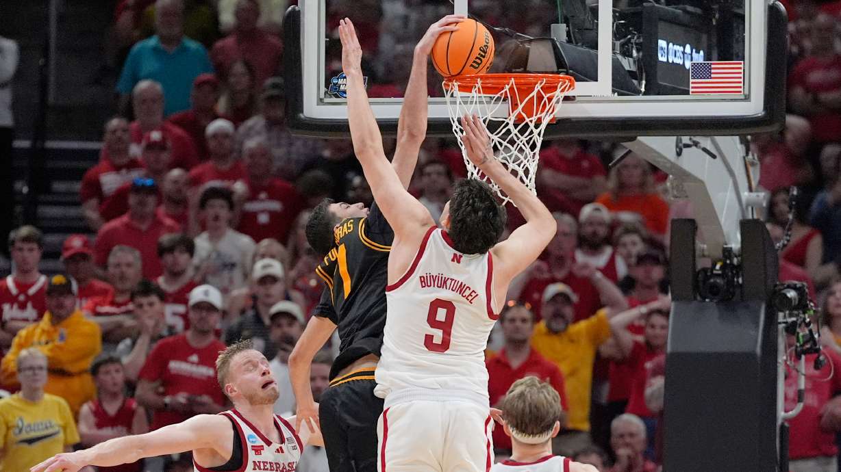 Iowa forward Alvaro Folgueiras (7) dunks over Nebraska forward Berke Buyuktuncel (9) during the second half in the Sweet 16 of the NCAA college basketball tournament Thursday, March 26, 2026, in Houston.