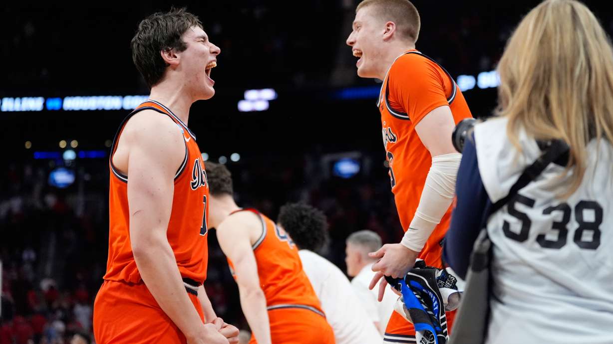 Illinois players celebrate after defeating Houston in the Sweet 16 of the NCAA college basketball tournament Friday, March 27, 2026, in Houston.
