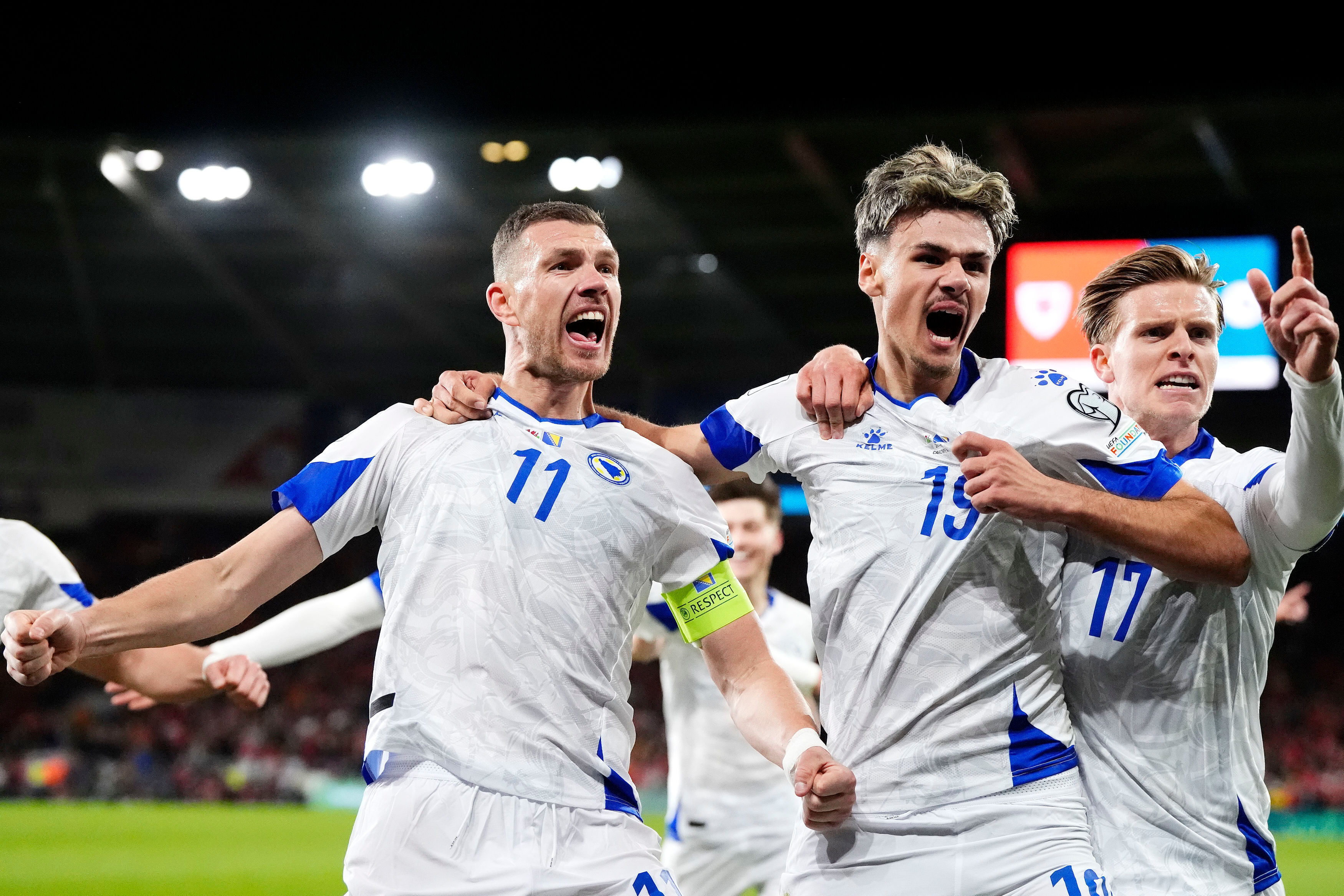 Bosnia and Herzegovina's Edin Dzeko, left, celebrates with team-mates after scoring their side's first goal during the World Cup playoff semifinal soccer match between Wales and Bosnia and Herzegovina in Cardiff, Wales, Thursday, March 26, 2026. 