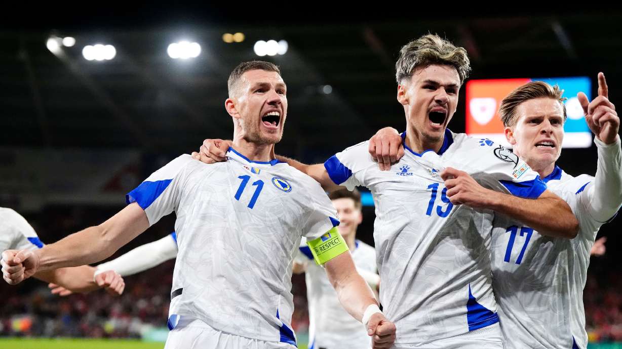 Bosnia and Herzegovina's Edin Dzeko, left, celebrates with team-mates after scoring their side's first goal during the World Cup playoff semifinal soccer match between Wales and Bosnia and Herzegovina in Cardiff, Wales, Thursday, March 26, 2026.