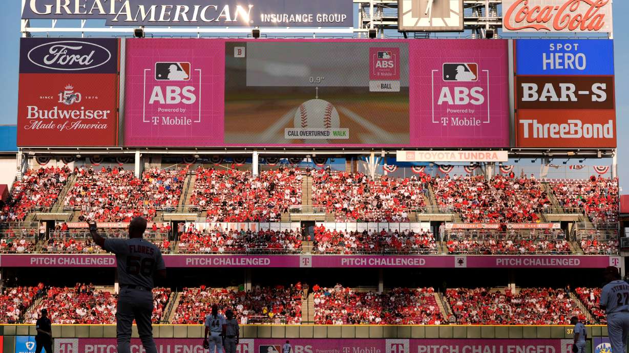 A call is overturned by Automated Ball-Strike System during the ninth inning of an opening-day baseball game between the Cincinnati Reds and the Boston Red Sox in Cincinnati, Thursday, March 26, 2026.