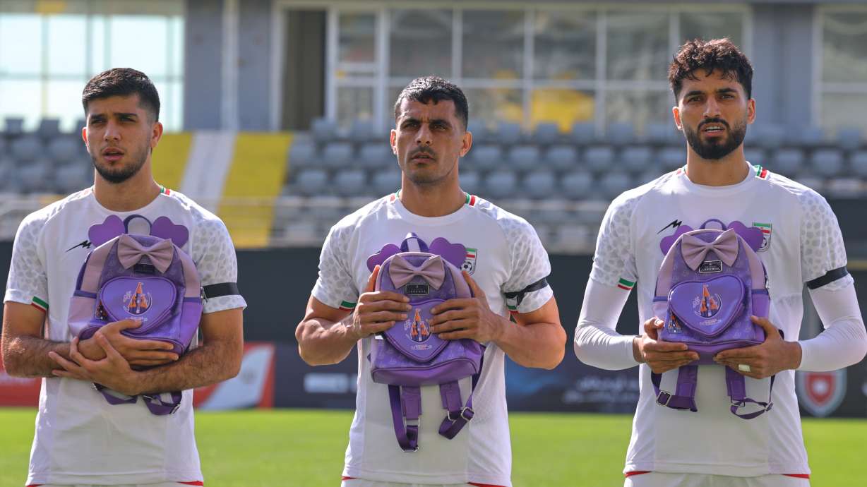 Iran's players sing national anthem holding school bags symbolizing children allegedly killed in a U.S. strike on a school in Minab before a friendly soccer match between Iran and Nigeria, in Antalya, southern Turkey, Friday, March 27, 2026.