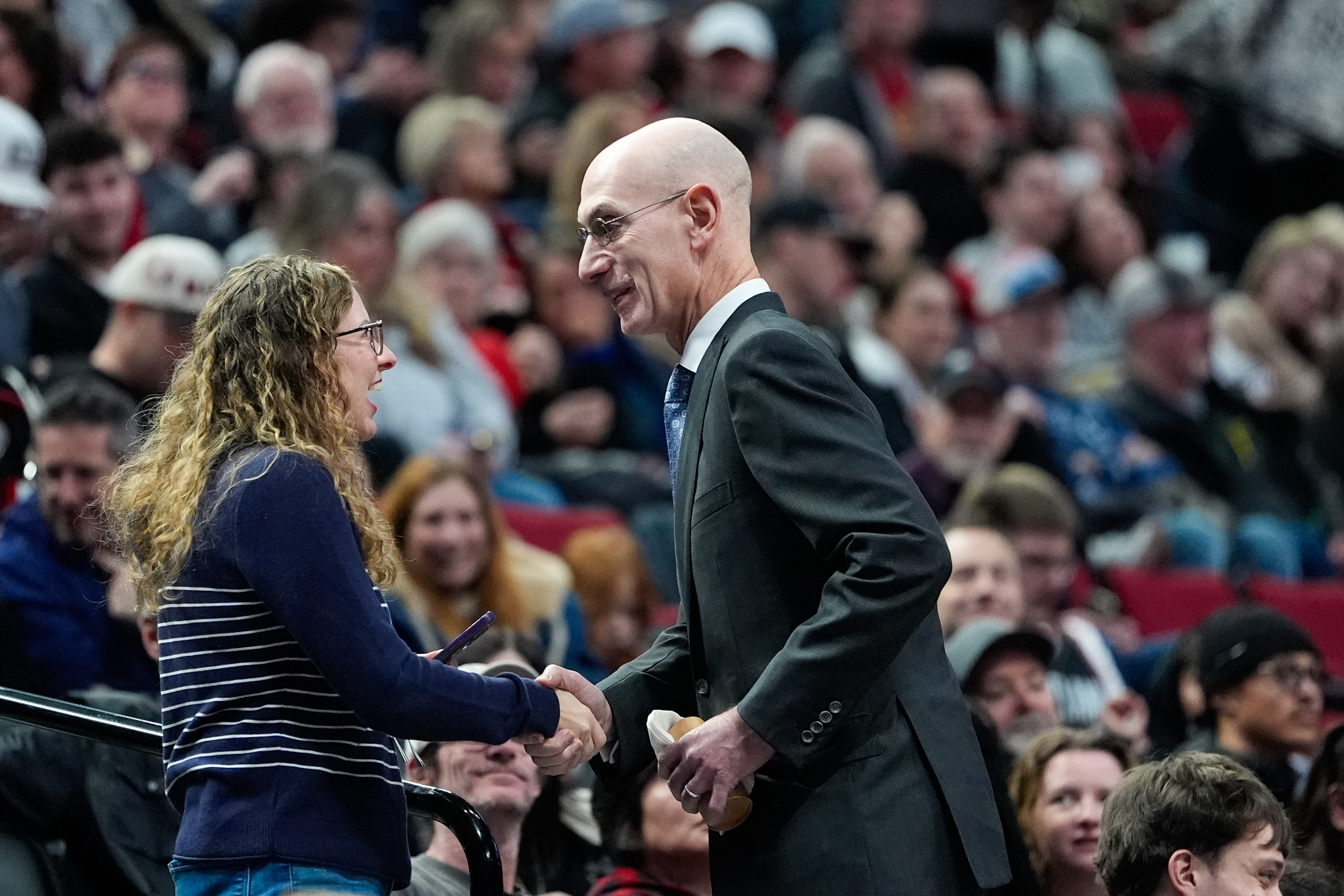 NBA commissioner Adam Silver greets a fan during an NBA basketball game between the Portland Trail Blazers and the Utah Jazz, Friday, March 13, 2026, in Portland, Ore. 