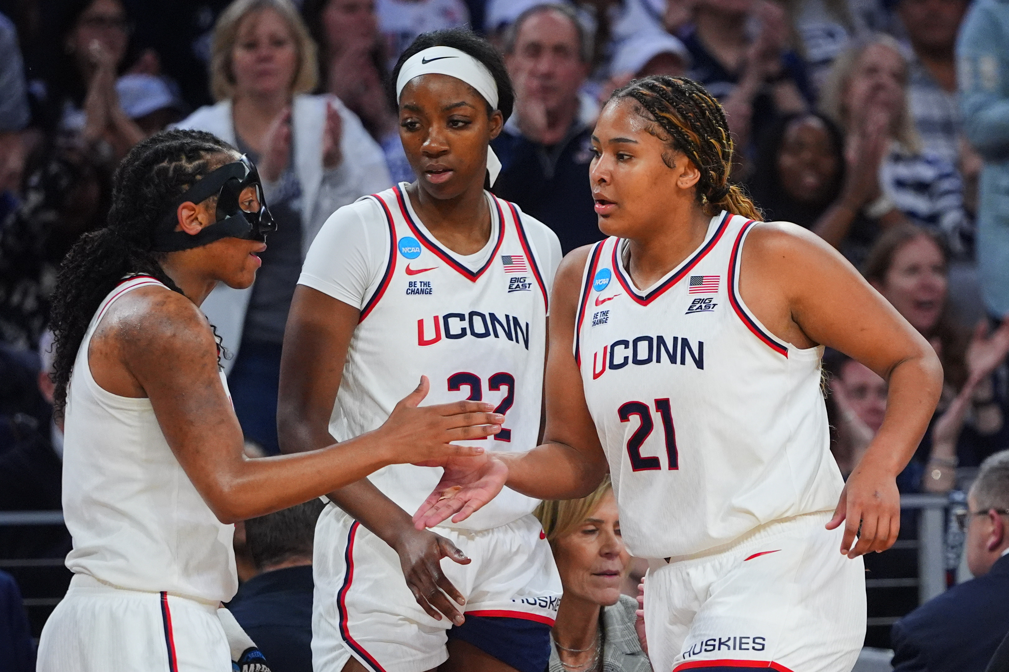 UConn's KK Arnold, left, Serah Williams (22) and Sarah Strong (21) celebrate late in the second half in the Sweet 16 of the NCAA college basketball tournament against North Carolina, Friday, March 27, 2026, in Fort Worth, Texas. 